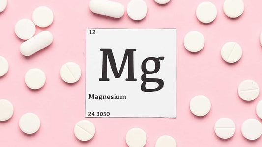 White tablets on a pink background around the periodic symbol for magnesium Mg. How long does it take for magnesium supplements to work?