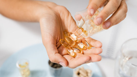Woman with omega-3 capsule in palm of hand ready to take. 