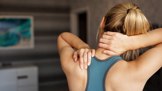 Best Supplements for Muscle Pain and Stiffness. Woman holding shoulder and neck to indicate muscle pain and stiffness.