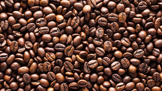 Caffeine Anhydrous: Benefits, Weight Loss and Side Effects. A pile of roasted coffee beans is shown, illustrating a popular natural source of caffeine.