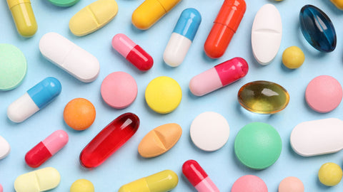 Collection of colorful dietary supplements posing the question, "Can I Take Vitamin D and Magnesium Together?"