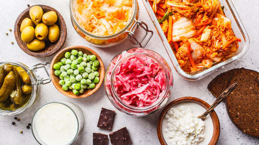 Different forms of probiotics in jars and dishes. Posing the question Do Probiotics Cause Gas?