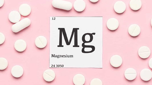 White tablets on a pink background around the periodic symbol for magnesium Mg. How long does it take for magnesium supplements to work? 