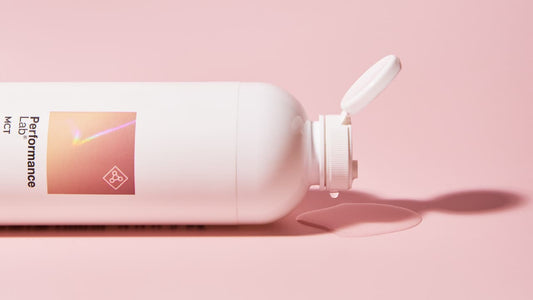 MCT Oil supplement bottle on a pink background