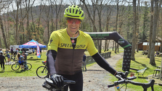 Performance Lab® customer John with his gravel bike at a cycling event, enjoying one of his favourite outdoor activities.