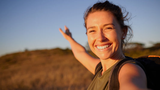 Exploring B Vitamins Benefits for Your Health and Well-Being. A woman smiles while out hiking in nature