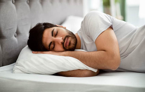 Turmeric and Sleep: Are they connected? A man sleeps soundly on a bed