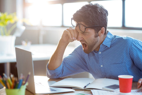 Does tyrosine make you sleepy? A tired man yawns while sat at his desk