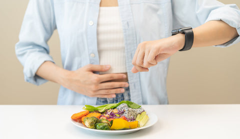 Fasting for immunity to boost health and immune system. A woman holds her stomach waiting for time to eat