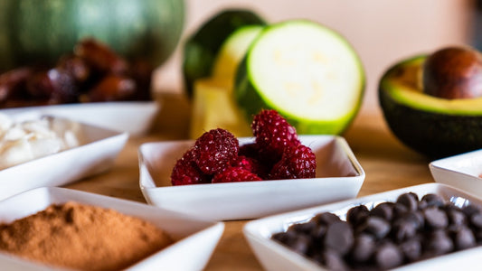 Food synergy. Close-up of assorted fresh ingredients, including berries and other foods arranged in small dishes.