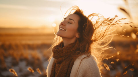 Liposomal glutathione uses and benefits for optimum health and wellness. A woman turns her face to the sun