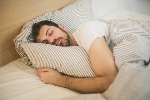 How long does melatonin stay in your system? A man sleeping.