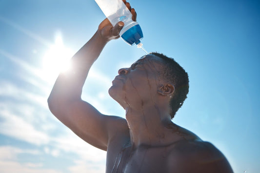 Will dehydration cause joint pain? Man cooling off with water under the sun. Hydration is essential for joint cushioning, flexibility, and overall health.