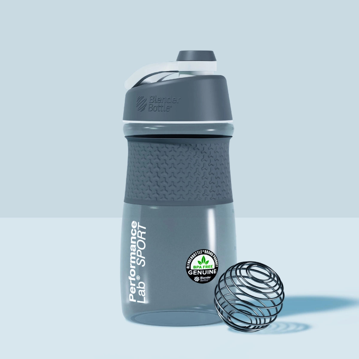 Performance Lab SPORTMixer bottle next to a wire whisk ball.