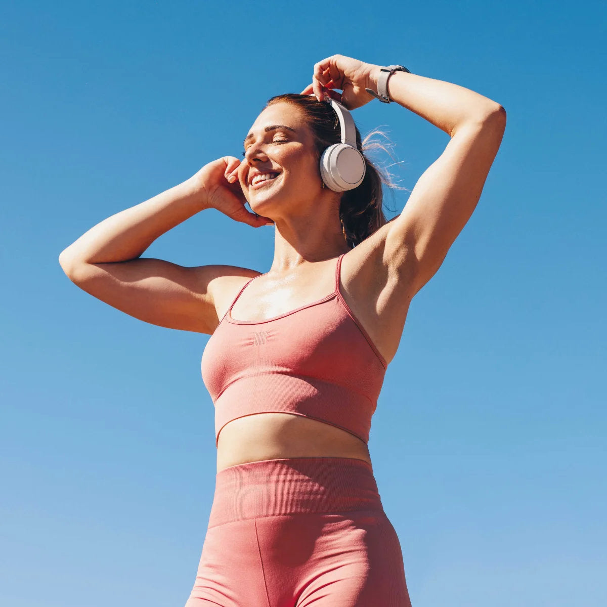 lady smiling working out with headphones on