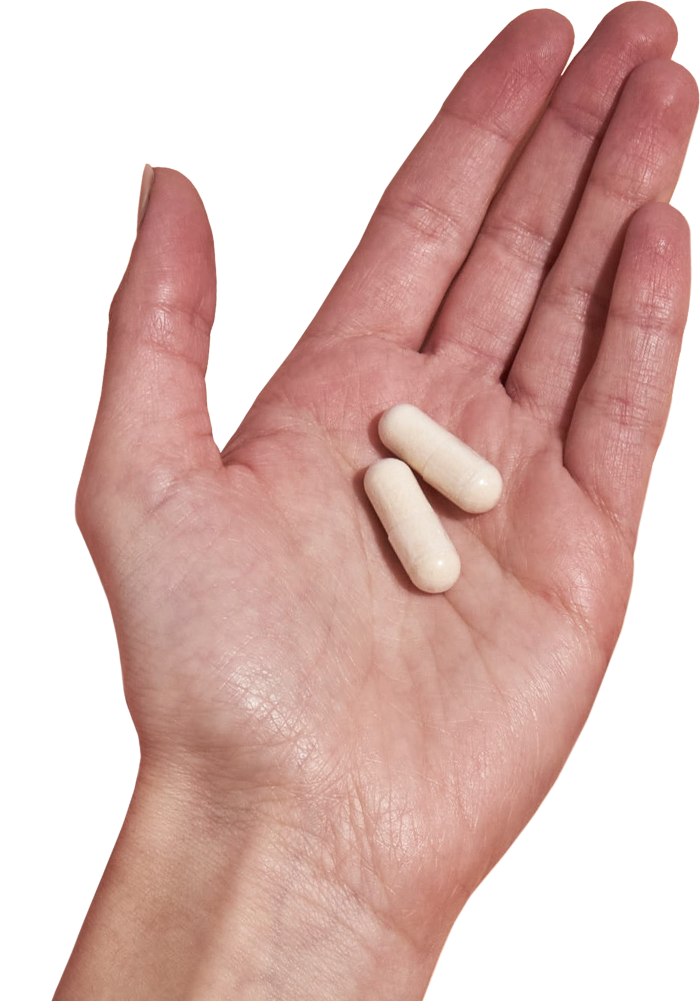image of hand holding 2 Performance Lab® Magnesium capsules