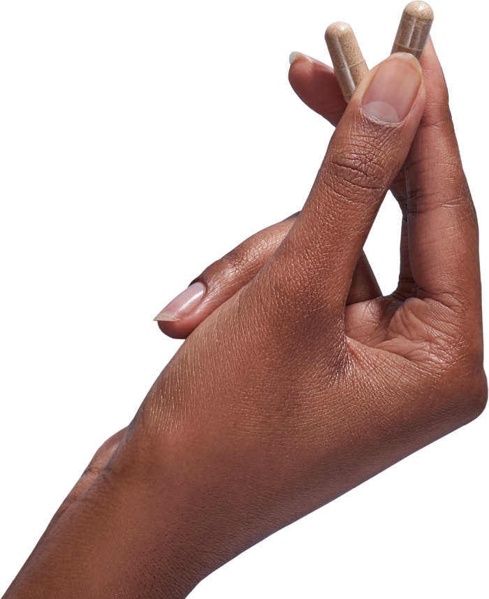 image of hand holding 2 Performance Lab® Vitamin C capsules